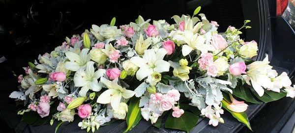 "casket top flowers spray"